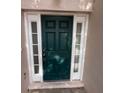 Close up of the front door of a home with decorative sidelights and an electronic keypad at 266 Vervain Ave, Davenport, FL 33837