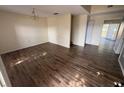 A bright living room featuring wood-look floors and a chandelier at 266 Vervain Ave, Davenport, FL 33837