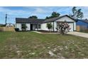 Charming single-story home with a well-maintained lawn and an attached two car garage at 3055 Kirkland St, Deltona, FL 32738