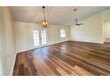 Spacious living room with new hardwood floors, ceiling fan, and French doors to the backyard at 3055 Kirkland St, Deltona, FL 32738