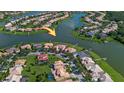 Gorgeous aerial view highlighting a waterfront home with lake access in a quiet neighborhood at 3774 Eagle Isle Cir, Kissimmee, FL 34746