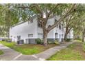 View of condo exterior and lawn showing trees, landscaping, and building design at 4356 S Kirkman Rd # 514, Orlando, FL 32811
