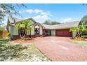 Beautifully landscaped front yard featuring a circular brick driveway at 4523 Wyndcliff Cir, Orlando, FL 32817