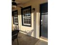 Inviting front entrance with stylish black trim windows and a ceiling fan for comfort on the porch at 4805 Sw 171St Ct, Dunnellon, FL 34432