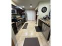 Well-lit kitchen featuring stainless steel appliances, granite countertops, and dark wood cabinetry at 603 Zinnia Dr, Casselberry, FL 32707