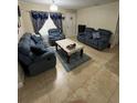 Cozy living room with plush blue furniture and patterned curtains, perfect for relaxing at 603 Zinnia Dr, Casselberry, FL 32707