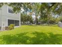 Lush, expansive lawn surrounding the townhome provides a serene and private outdoor space with mature trees at 9492 Flowering Cottonwood Rd # 82, Orlando, FL 32832