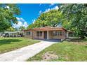Inviting single-story home with a covered carport, lawn, and fresh exterior paint at 102 Mayrose Dr, Sanford, FL 32771