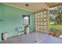 Inviting front porch featuring decorative concrete blockwork, seating, and modern fixtures at 1210 S Palmetto Ave, Sanford, FL 32771