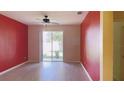 Bright, airy living room with wood-look flooring and sliding glass door leading to the backyard at 12630 Old Plantation Ln, Orlando, FL 32824