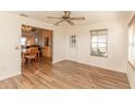 Open concept living room featuring luxury laminate flooring and plenty of natural light at 1425 Hollyberry Pl, The Villages, FL 32162