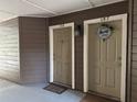 Condo entryway showcases unit doors 107 and 108 with welcome mats and decorative exterior fixtures at 199 Afton Sq # 108, Altamonte Springs, FL 32714