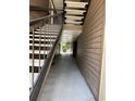 Hallway leading to stairwell with neutral walls and flooring, providing a glimpse of the outdoor landscape at 199 Afton Sq # 108, Altamonte Springs, FL 32714