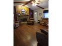 Cozy living room with a stone fireplace, hardwood floors and comfortable seating at 2320 Ne 43Rd St, Ocala, FL 34479