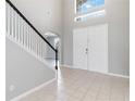 Inviting foyer with a staircase and tiled floor at 2871 Paige Dr, Kissimmee, FL 34741