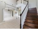 Open-concept living room features tile floors and staircase at 2871 Paige Dr, Kissimmee, FL 34741