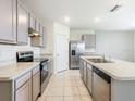 Well-equipped kitchen with stainless steel appliances, gray cabinetry, and a functional center island at 313 Sofia Ln, Lake Alfred, FL 33850