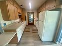 Efficient kitchen with vintage cabinets, countertops, and appliances provides ample space at 3695 Dale Ct, Mount Dora, FL 32757