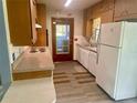 Well-lit kitchen with vintage appliances, countertops, and wood cabinets ready for updates at 3695 Dale Ct, Mount Dora, FL 32757