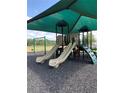 Community playground with multiple slides, climbing features, and a swing set under a shaded canopy at 406 Cool Summer Ln, Davenport, FL 33837
