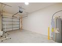 Spacious garage with a garage door opener and hot water tank at 463 Cape Honeysuckle Pl, Sanford, FL 32771