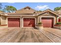 Exterior view of a home featuring a three car driveway and red garage doors at 7421 Sugar Bend Dr # 7421, Orlando, FL 32819