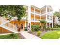 Condo building shows landscaped grounds, covered walkways, and exterior stairs to upper units at 1109 New Providence # 141109, Davenport, FL 33897