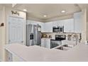 Bright kitchen features stainless appliances, recessed lighting, a pantry, and ample counter space at 141 Winsor Ave, Davenport, FL 33837