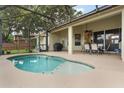 Inviting screened-in pool and patio area perfect for outdoor entertaining and relaxation, with outdoor dining set at 165 Fig Tree Run, Longwood, FL 32750