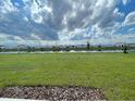 Expansive backyard view overlooking a serene pond and neighborhood homes at 228 Aquamarine Ln, Kissimmee, FL 34758