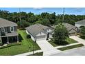 An aerial view of a home with a well-manicured lawn and professional landscaping at 2718 Limerick Cir, Grand Island, FL 32735