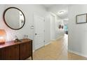 Bright and spacious hallway with tile flooring and neutral wall colors at 2718 Limerick Cir, Grand Island, FL 32735