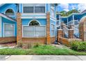 A close-up exterior of a two-story condo showcases brick accents and well-maintained landscaping at 2739 N Poinciana Blvd # 77, Kissimmee, FL 34746