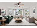 Bright living room with a ceiling fan, bay window, and comfortable furnishings, perfect for relaxation at 2739 N Poinciana Blvd # 77, Kissimmee, FL 34746