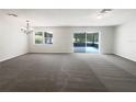 Spacious living room featuring neutral walls, carpet, recessed lighting, and a glass sliding door at 281 Covent Gardens Pl, Deltona, FL 32725