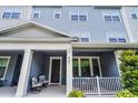 Inviting front porch with seating area and manicured landscaping at 461 Diamond Dove Cv, Winter Springs, FL 32708