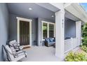 Close-up view of the cozy front porch with elegant seating at 461 Diamond Dove Cv, Winter Springs, FL 32708