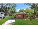 Charming single-story home with a covered carport and well-manicured lawn at 4757 Goldsboro Ct, Orlando, FL 32811