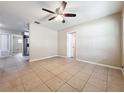 Bright living room featuring tile floors and a ceiling fan for added comfort at 4757 Goldsboro Ct, Orlando, FL 32811