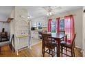 Eat-in kitchen features a dining table with seating and natural light at 500 E Gottsche Ave, Eustis, FL 32726