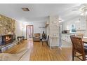 Spacious living room featuring stone fireplace and hardwood floors at 500 E Gottsche Ave, Eustis, FL 32726
