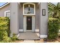 Elegant front entrance featuring a decorative wreath, sidelights, and a well-manicured garden, offering great curb appeal at 645 Macglenross Dr, Oviedo, FL 32765