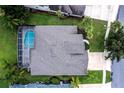 Overhead view of a house with a screened pool, gray roof, and well-kept yard in a suburban setting at 697 Broadoak Loop, Sanford, FL 32771