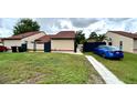 Nice single-story home showing a green lawn and a blue car parked, complemented by a concrete pathway at 761 Golden Sunshine Cir, Orlando, FL 32807