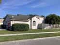 Single story home featuring tidy landscaping, a fenced yard, and an attached two car garage at 8647 Black Mesa Dr, Orlando, FL 32829