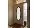 Elegant front door with decorative glass insert and sidelight, creating a welcoming entrance at 8647 Black Mesa Dr, Orlando, FL 32829