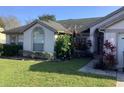 Well-maintained single-story home with lush landscaping, trimmed bushes and healthy green lawn at 8647 Black Mesa Dr, Orlando, FL 32829