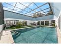 Beautiful backyard pool with clear water, lounge seating, BBQ, and screen enclosure at 9353 Gotha Rd, Windermere, FL 34786