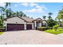 Charming single-story home featuring a brick driveway and three-car garage at 100 Verde Way, Debary, FL 32713