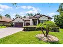 Attractive single-story home with three-car garage, beautiful landscaping and a brick driveway at 100 Verde Way, Debary, FL 32713